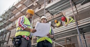 Project superintendent and foreman discussing plans at construction site.