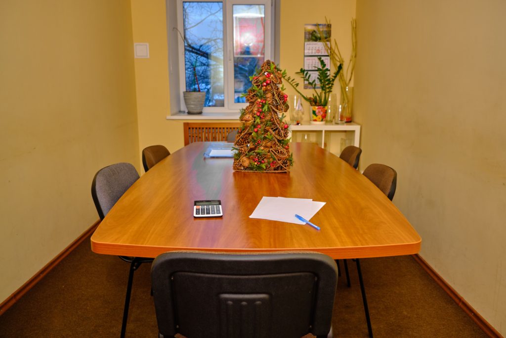 An old, terrible conference room in a crummy commercial building