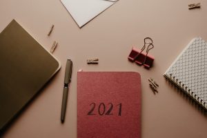 closeup of desk with office supplies & 2021 planner