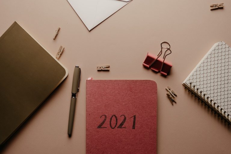 closeup of desk with office supplies & 2021 planner