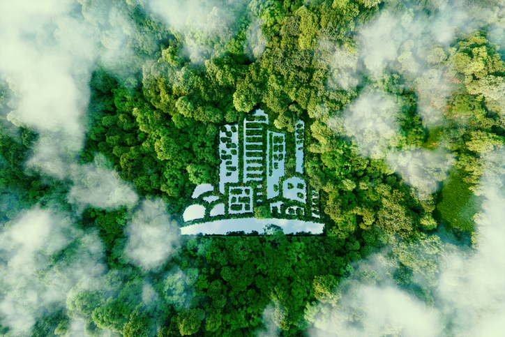 visual metaphor for green building: city-shaped lake in the middle of a lush forest