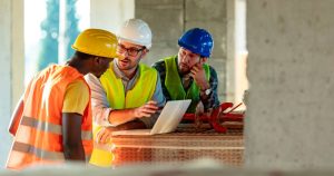 Construction team working to reduce costs when working with construction professionals.