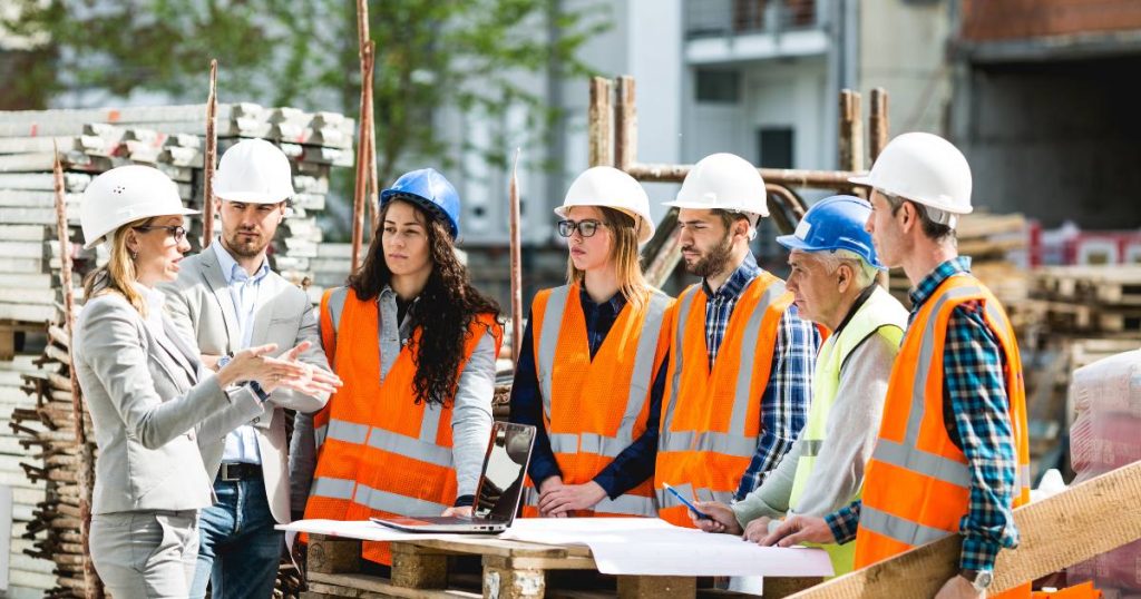 Building owner discussing communication and safety measures with specialty construction contractors