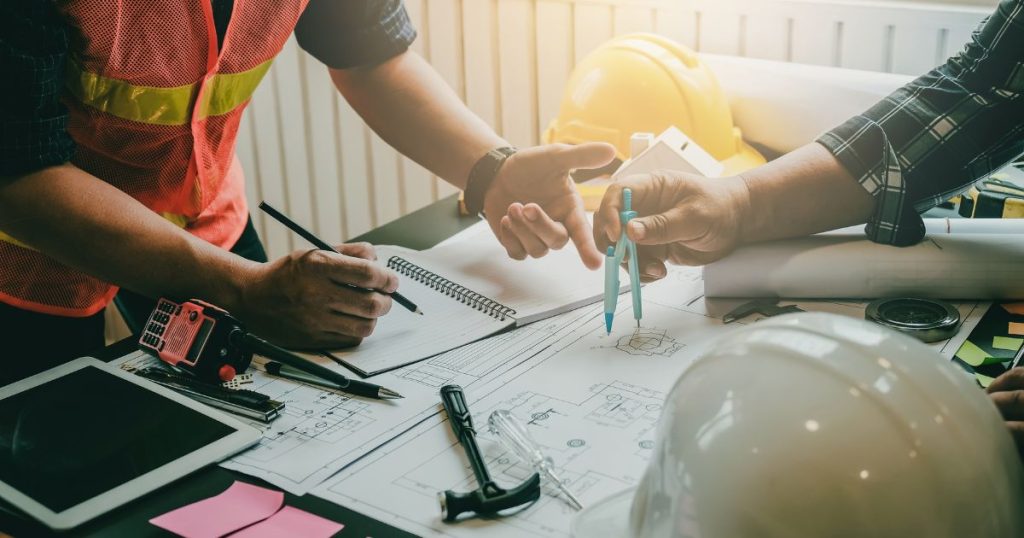 General contractor in PA and car dealership owner working on a strategic construction plan.