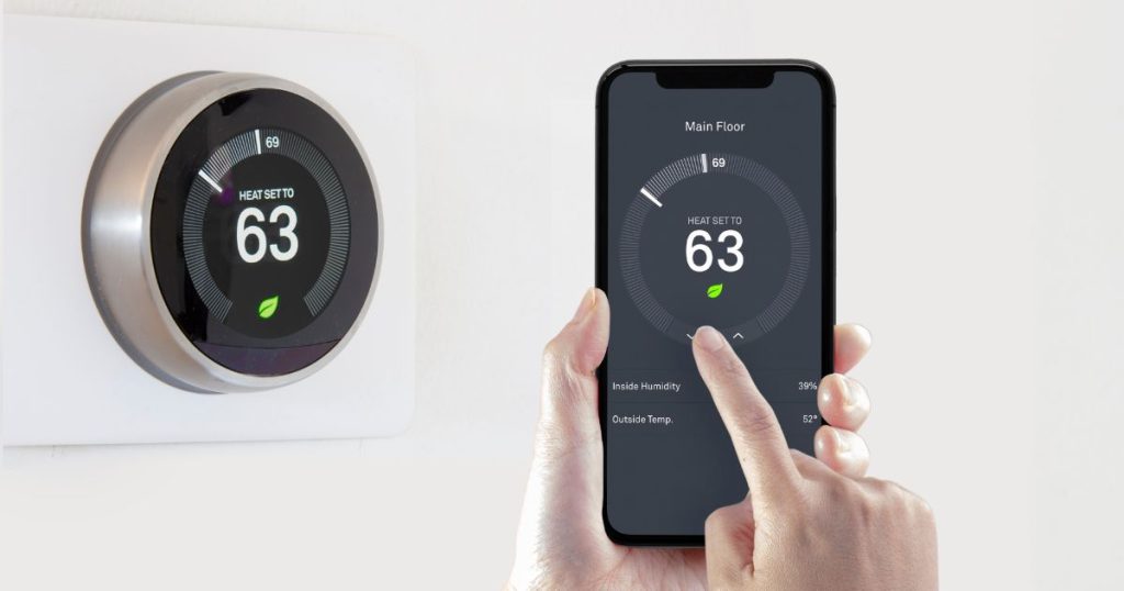 Person operating a smart thermostat from mobile phone